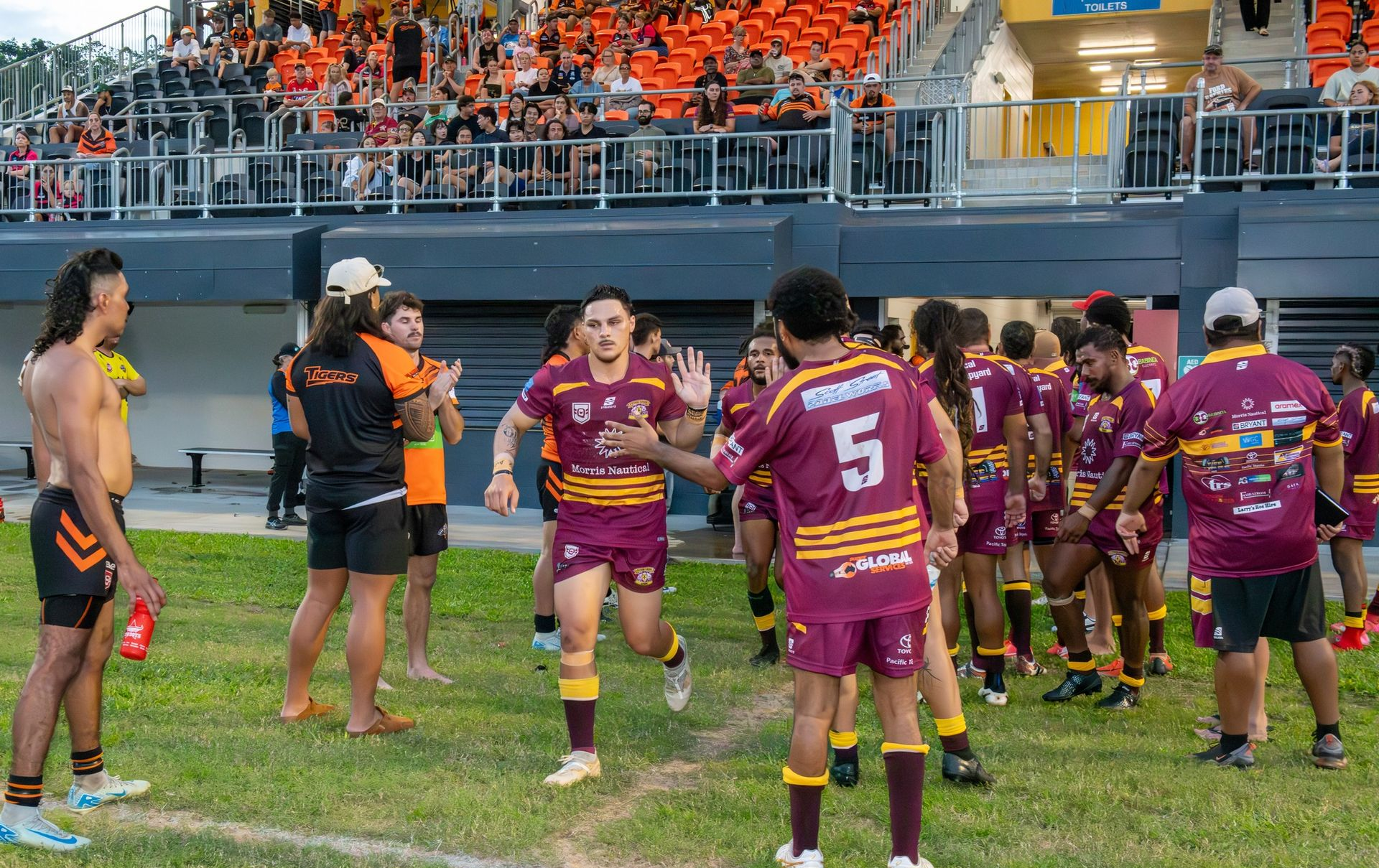 Rugby Players In Maroon And Gold Uniforms Celebrate On The Field — Amanda Jade Photography In Gordonvale, QLD