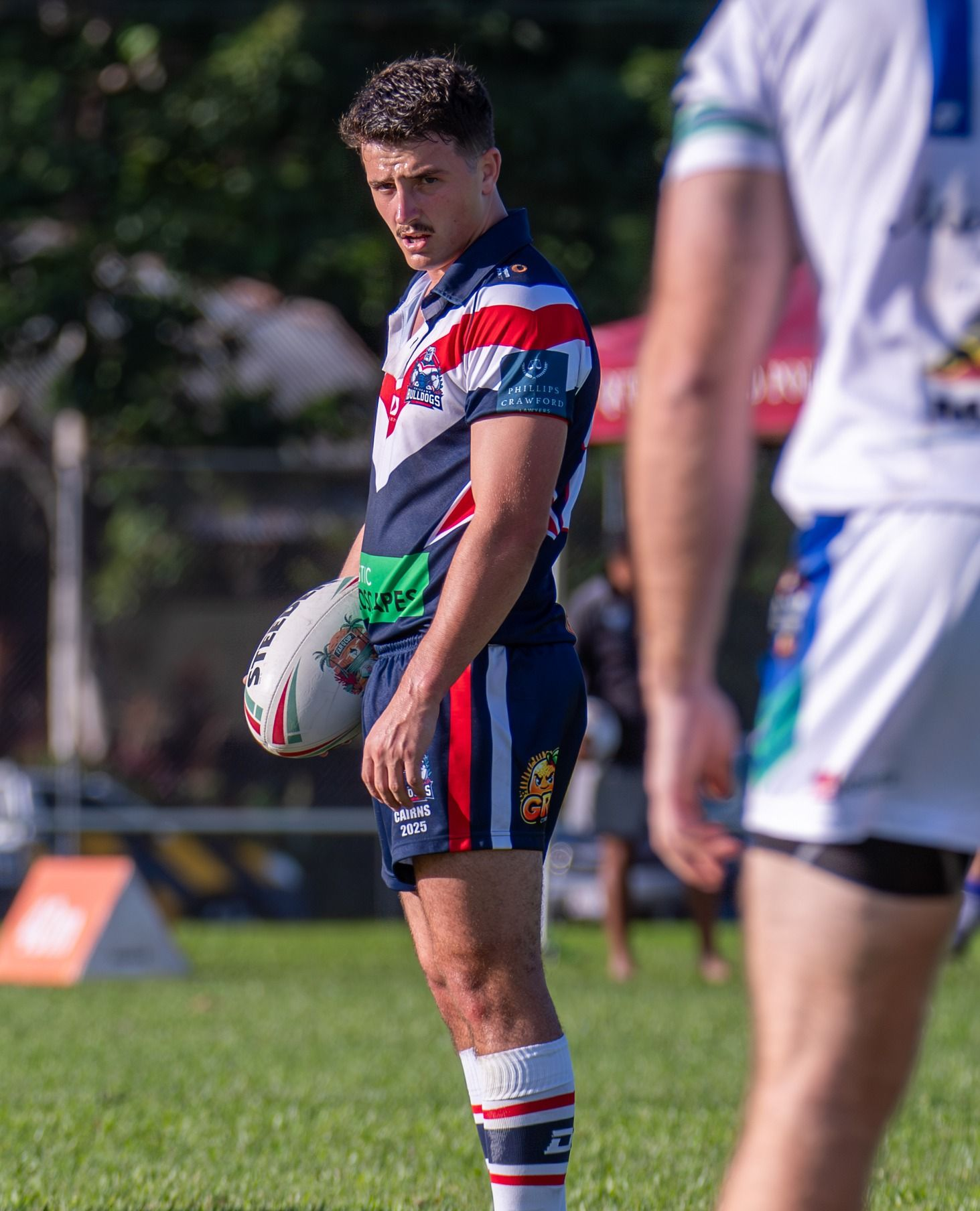 Rugby Player In A Navy, Red, And White Jersey Holding A Ball — Amanda Jade Photography In Mareeba, QLD