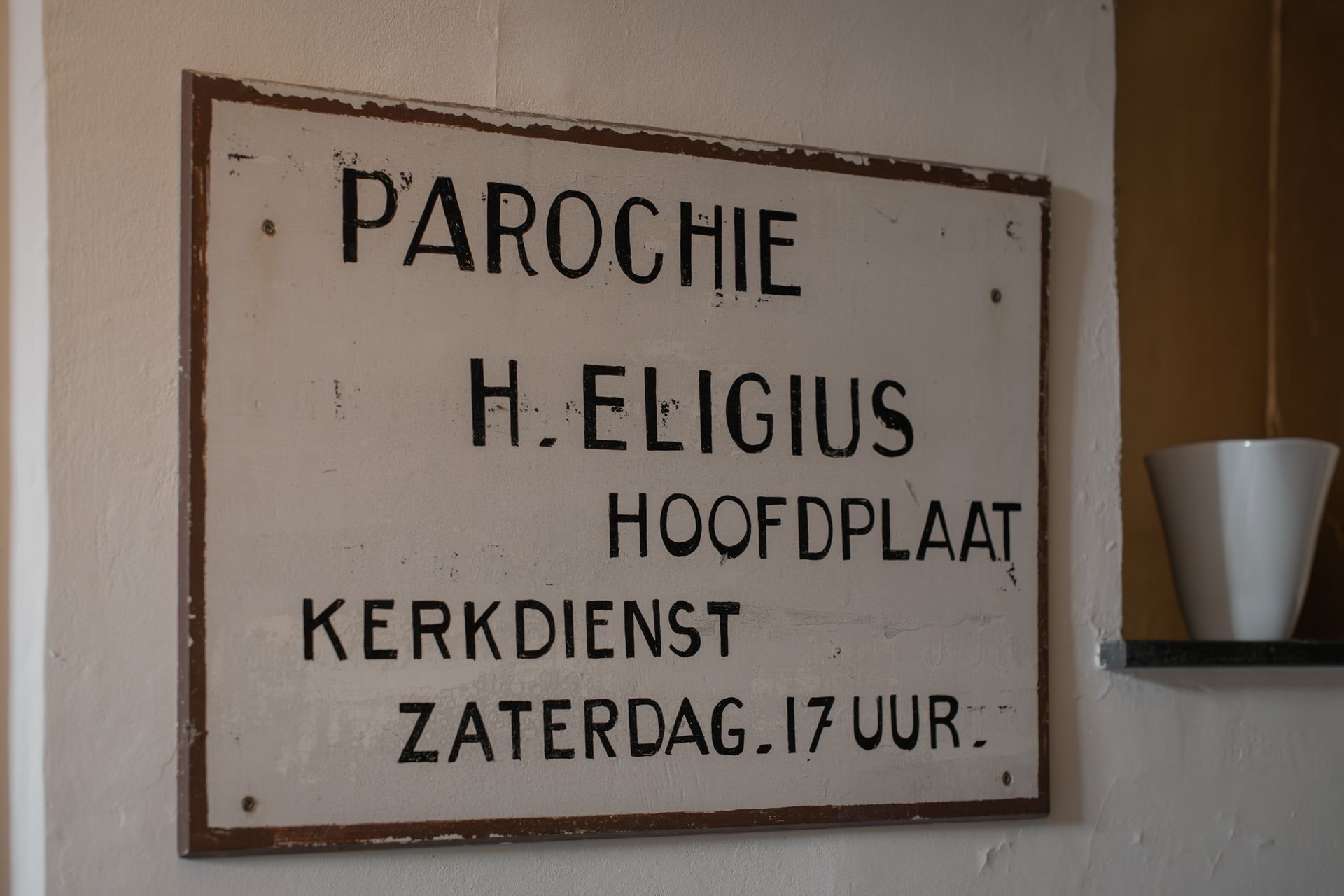 A white sign with black text reading 