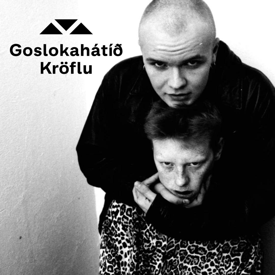 Two people: one bald, embracing another with red hair. Black and white, wall background.
