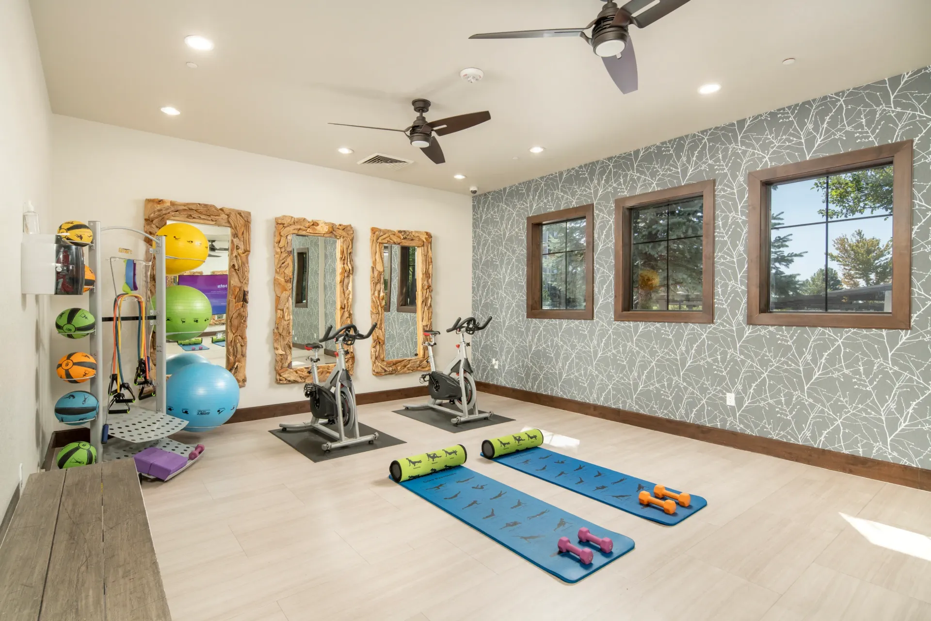 Fitness center with exercise bikes, yoga mats, and free weights at Elevation in Flagstaff, AZ.