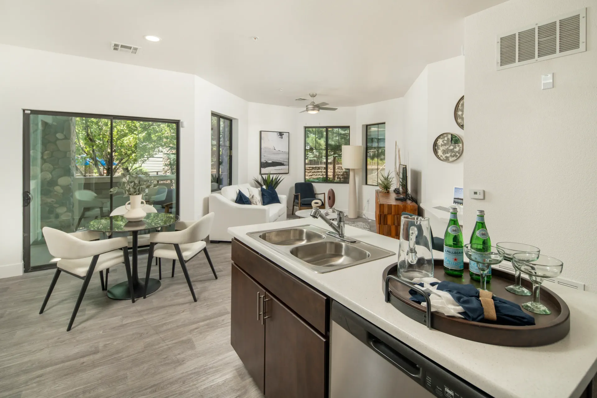 Modern kitchen and living area with dining table and patio access at Elevation in Flagstaff, AZ.