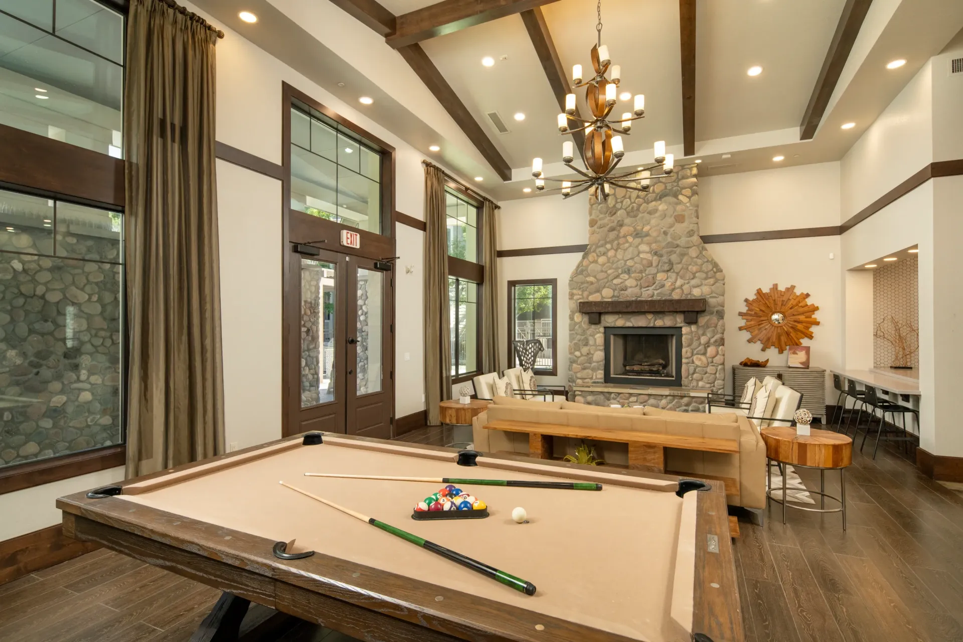 Community lounge with a pool table, fireplace, and seating areas at Elevation in Flagstaff, AZ.