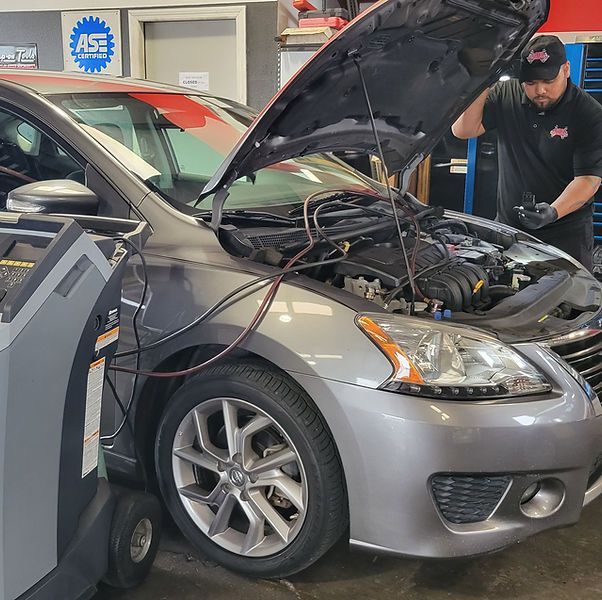 Mechanic Inspecting Car Under Hood | Cars Unlimited Auto Repair