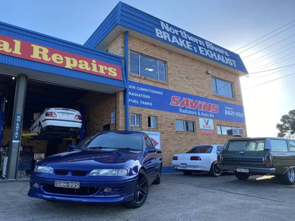 A Blue Car is Parked in Front of a Car Repair Shop — Savins Radiator Service In Lismore, NSW