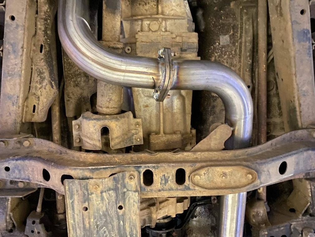 A Close Up of the Underside of a Car With a Exhaust Pipe — Savins Radiator Service In Lismore, NSW
