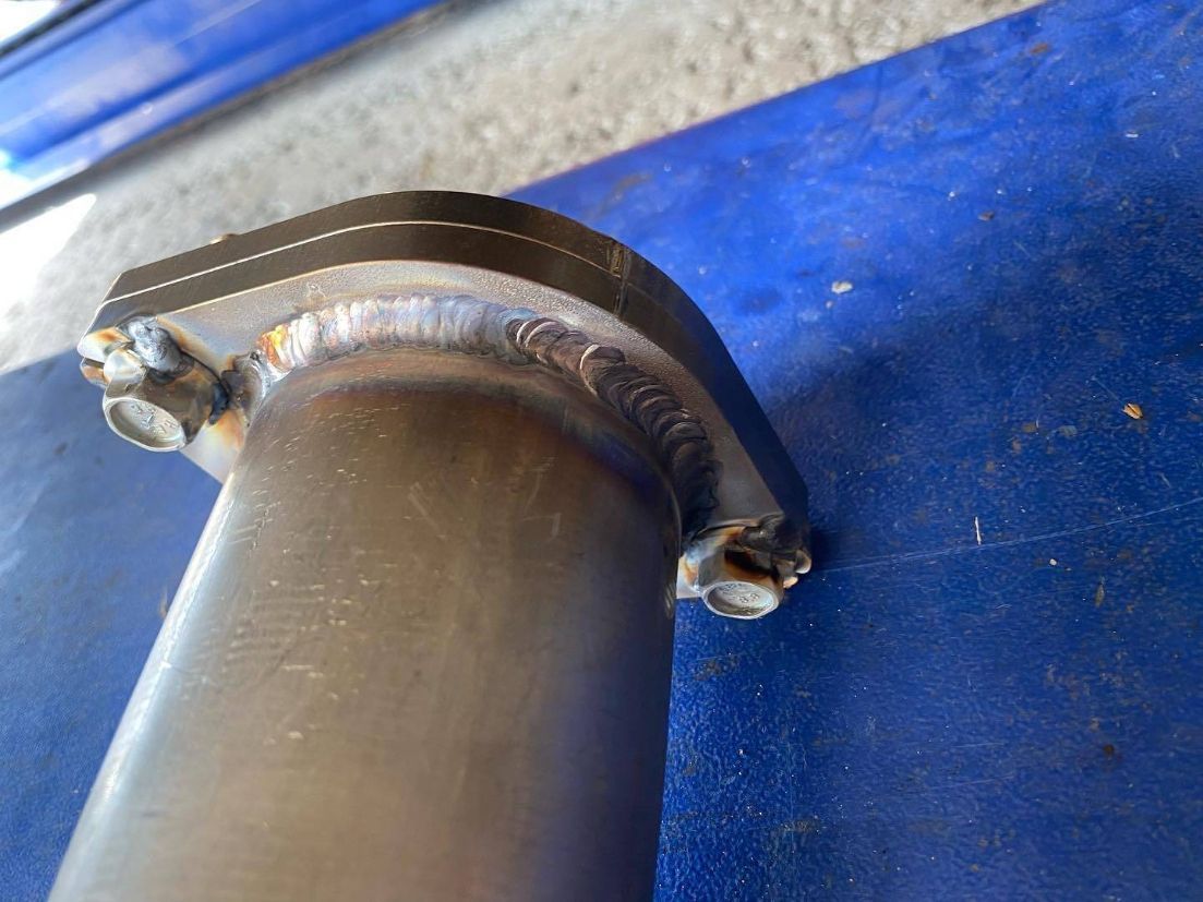 A Close Up of a Metal Pipe on a Blue Surface — Savins Radiator Service In Lismore, NSW