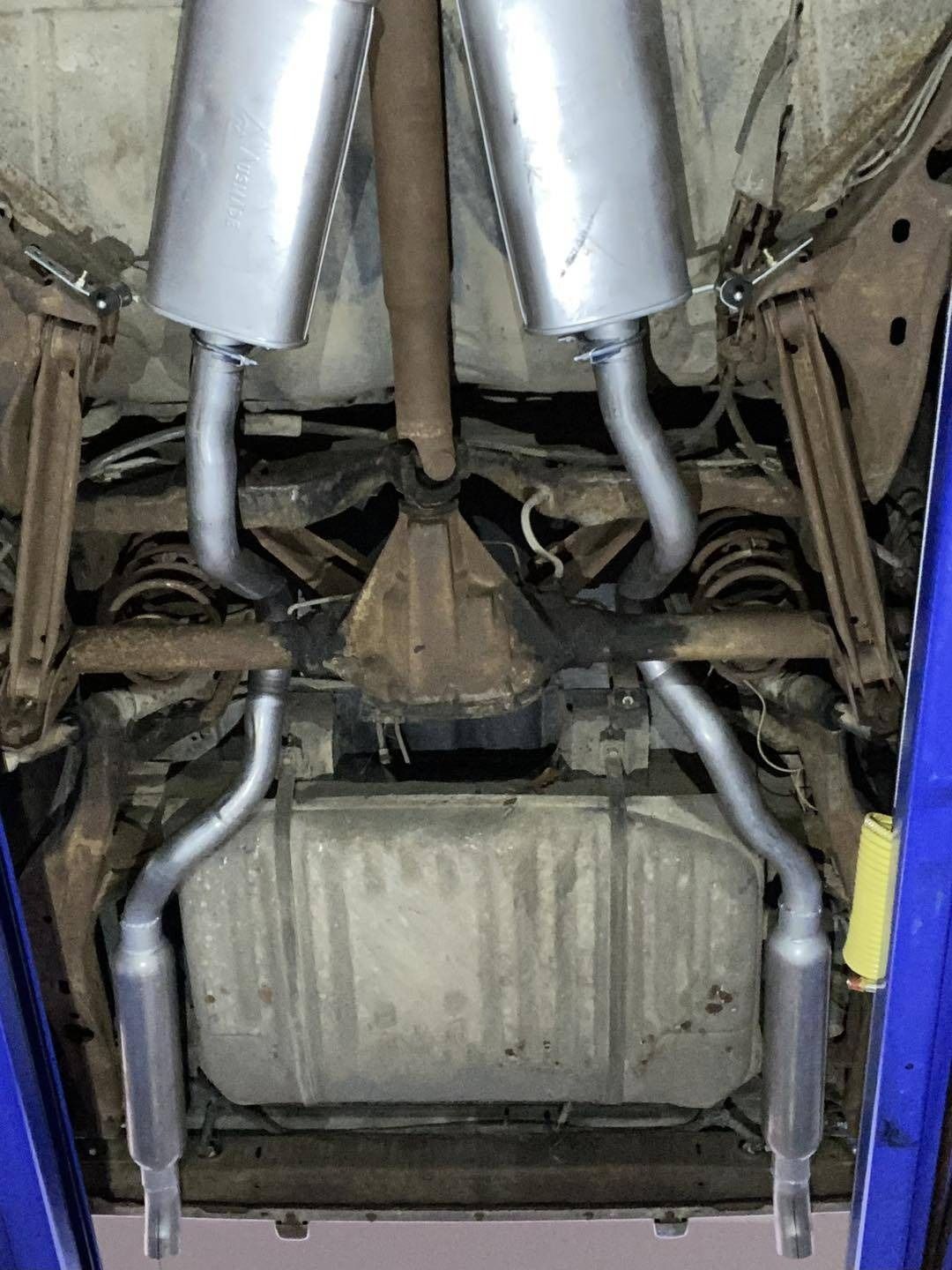 The Underside of a Car With Exhaust Pipes and a Gas Tank — Savins Radiator Service In Lismore, NSW