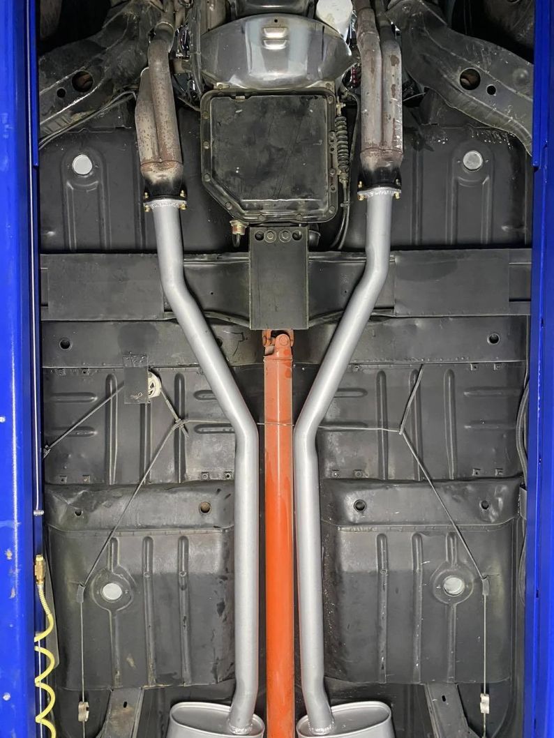 A Close Up of the Underside of a Car With Exhaust Pipes — Savins Radiator Service In Lismore, NSW
