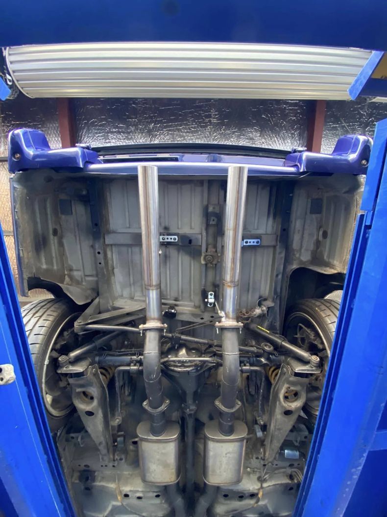 The Underside of a Car is Shown in a Blue Lift — Savins Radiator Service In Lismore, NSW