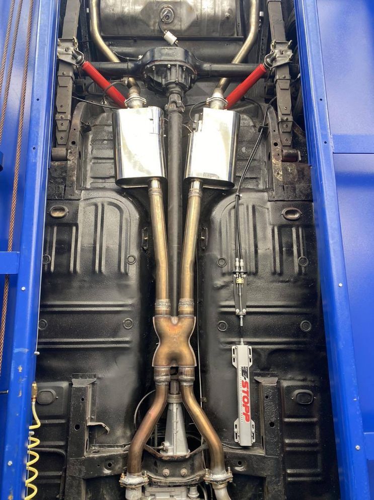 The Underside of a Car With Exhaust Pipes Attached to It — Savins Radiator Service In Lismore, NSW