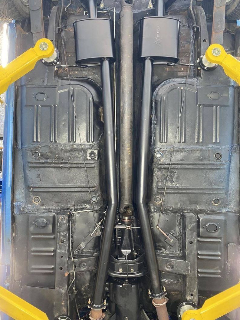The Underside of a Car With Exhaust Pipes Attached to It — Savins Radiator Service In Lismore, NSW