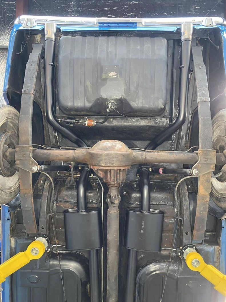 The Underside of a Car is Shown With a Tractor in the Background — Savins Radiator Service In Lismore, NSW