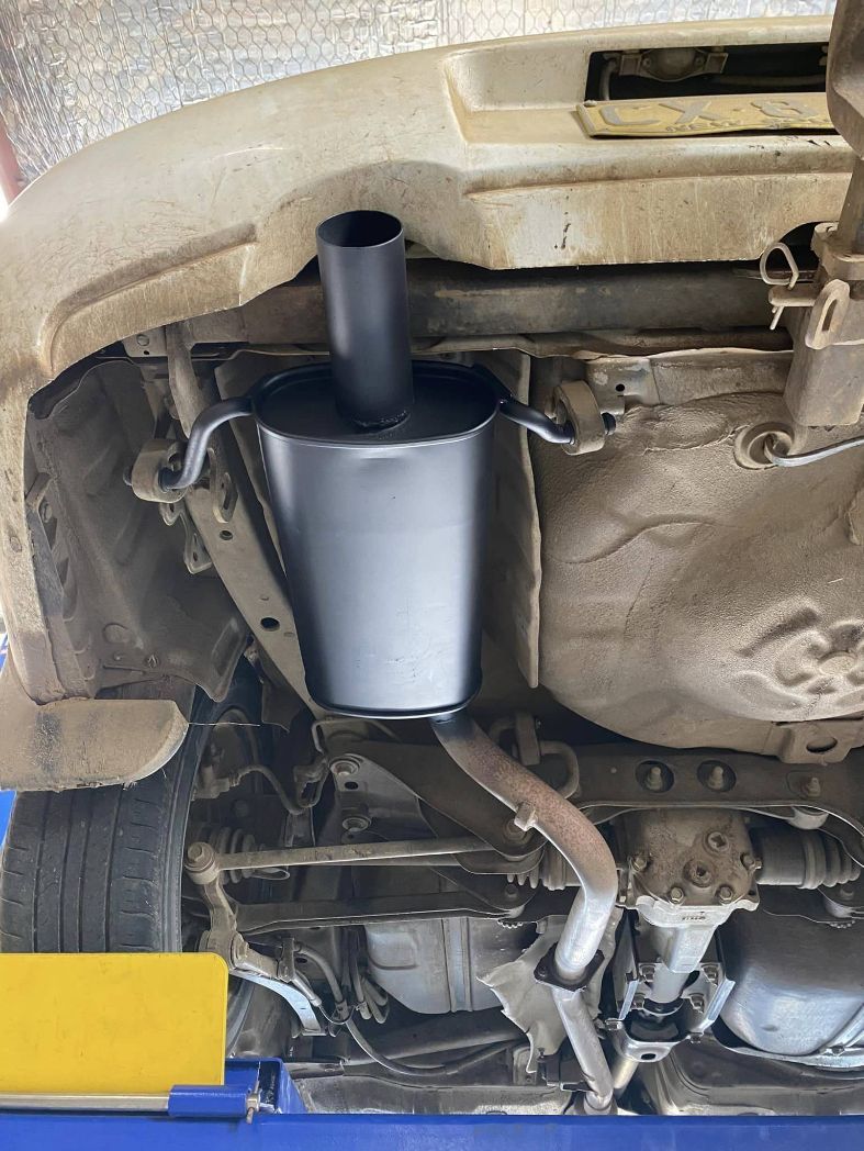 The Underside of a Car With a Exhaust Pipe Attached to It — Savins Radiator Service In Lismore, NSW