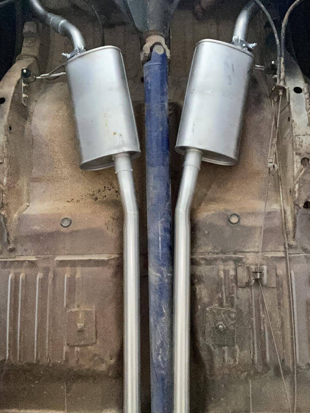 A Pair of Exhaust Pipes Attached to the Bottom of a Car — Savins Radiator Service In Lismore, NSW