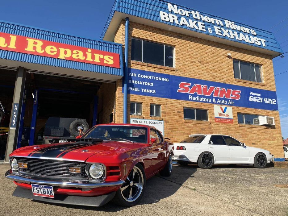 A Red Car is Parked in Front of a Building — Savins Radiator Service In Lismore, NSW