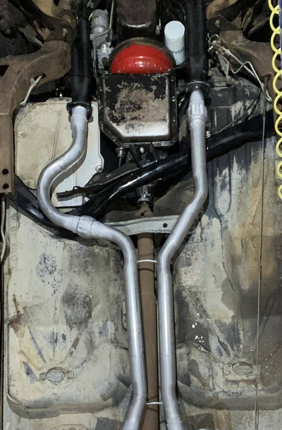 A Close Up of the Underside of a Car With Exhaust Pipes — Savins Radiator Service In Lismore, NSW