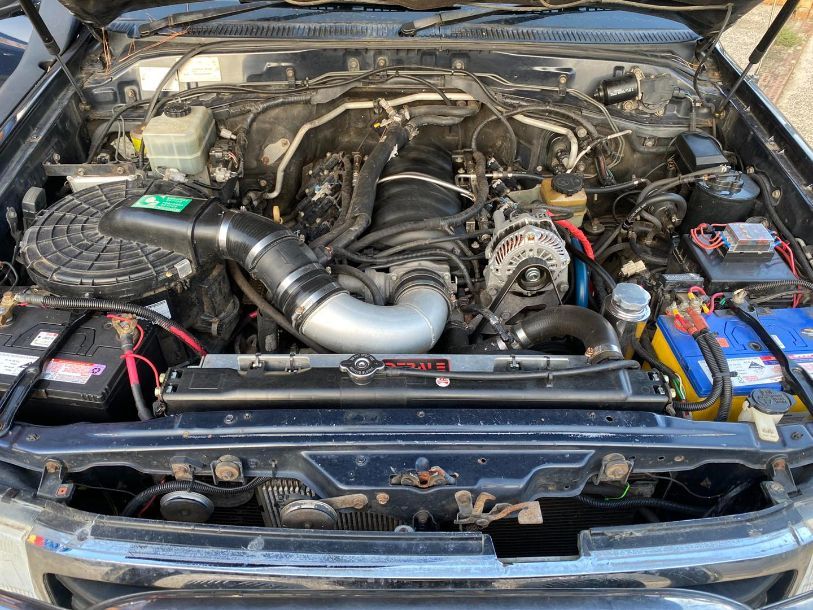 A Close Up of the Engine of a Car With the Hood Open — Savins Radiator Service In Lismore, NSW