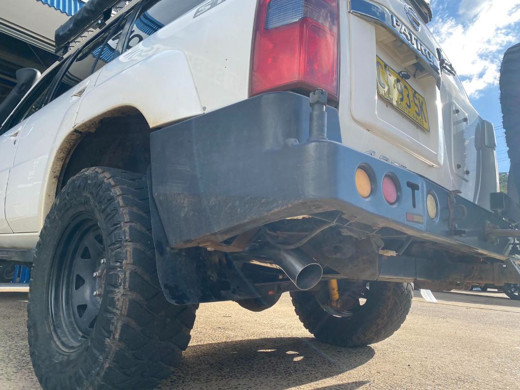 A White Truck With a Black Bumper is Parked on a Dirt Road — Savins Radiator Service In Lismore, NSW