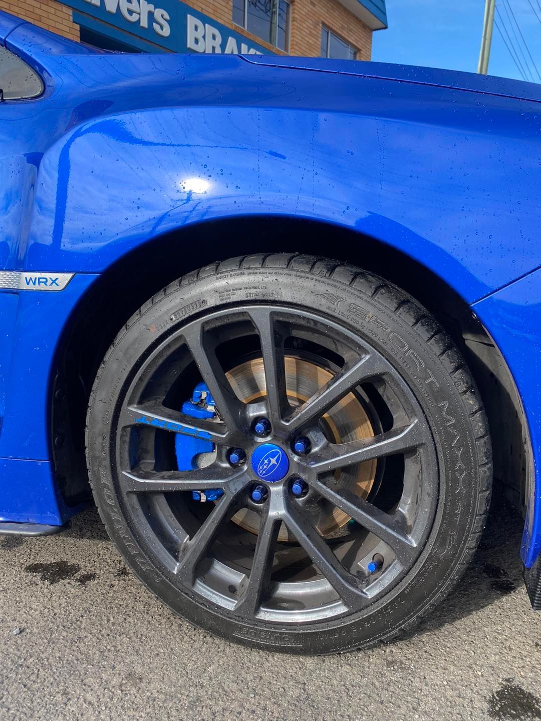 A Close Up of a Blue Car 's Wheel and Tire — Savins Radiator Service In Lismore, NSW