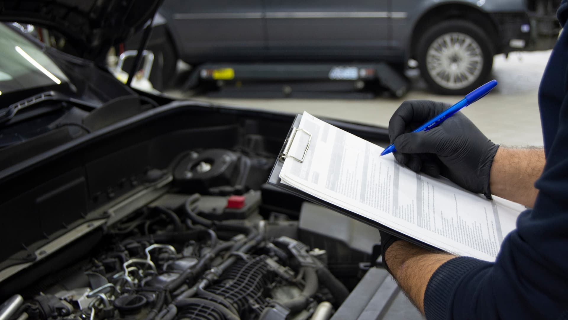 A Man is Writing on a Clipboard — Savins Radiator Service In Lismore, NSW