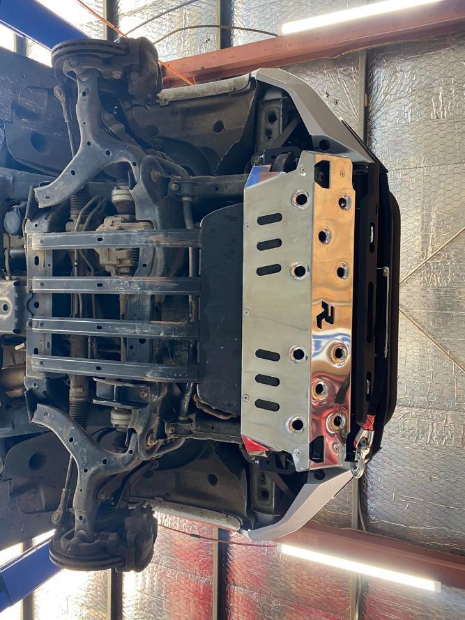A Car is Sitting on a Lift in a Garage — Savins Radiator Service In Lismore, NSW