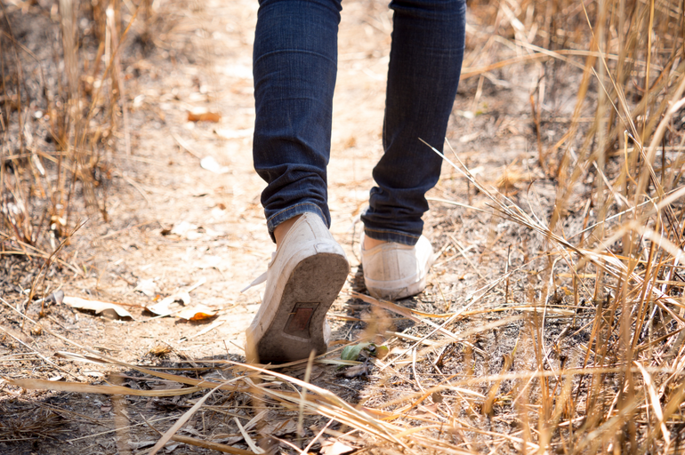 person walking on a path to represent taking steps to grow your business