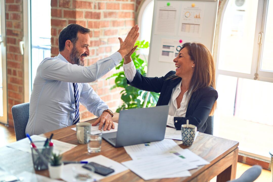 2 colleagues giving each other a high five