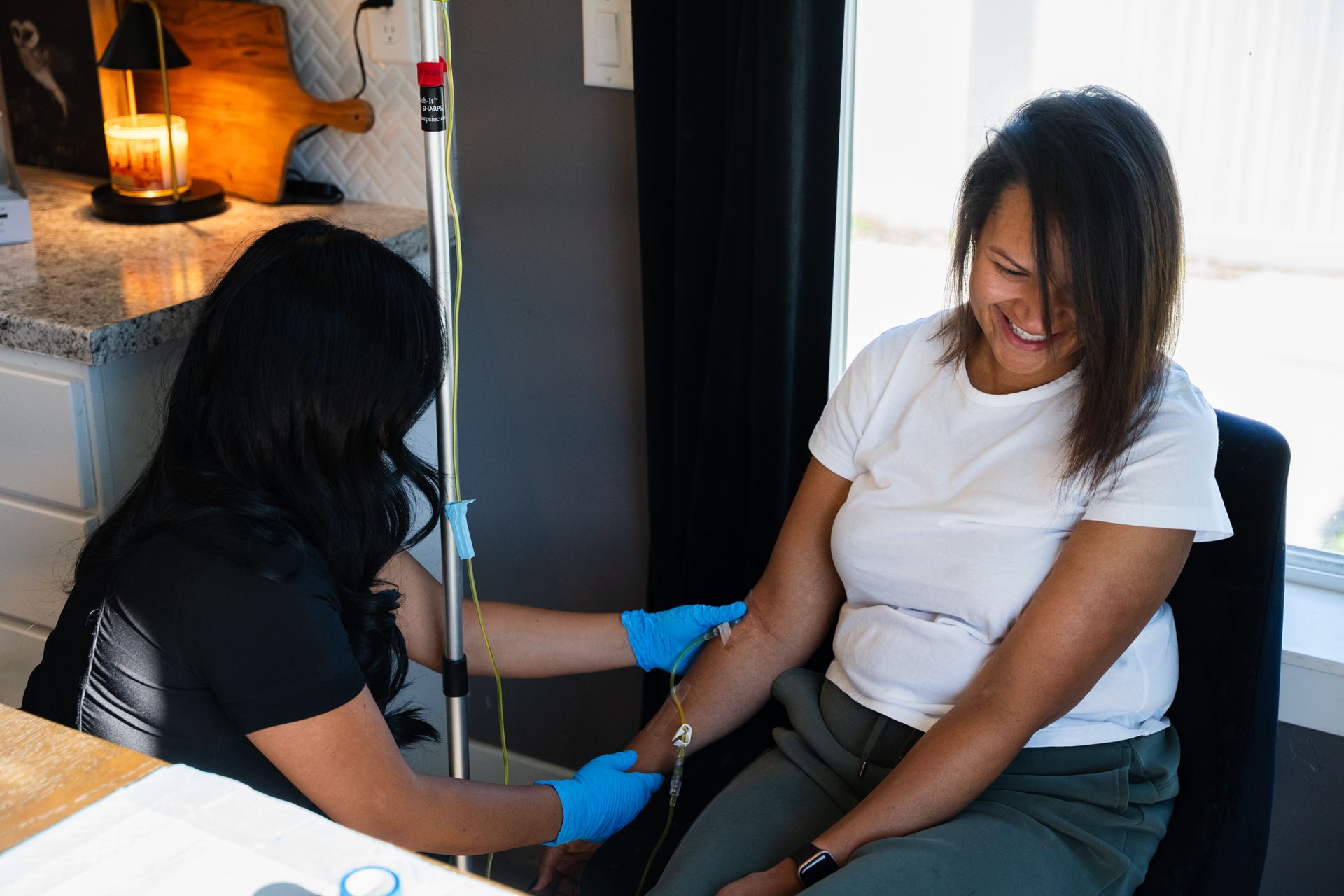 Nurse administering mobile IV therapy at a client's home