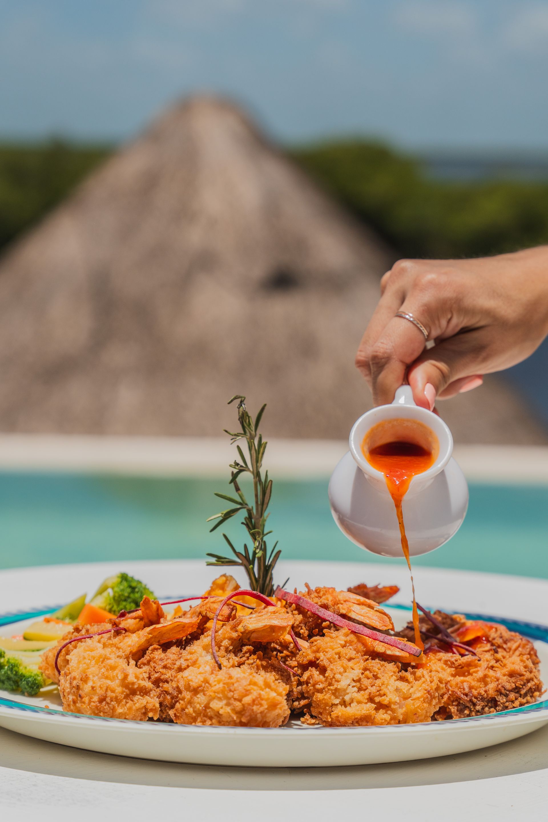 Un plato de comida y un vaso de agua sobre una mesa.