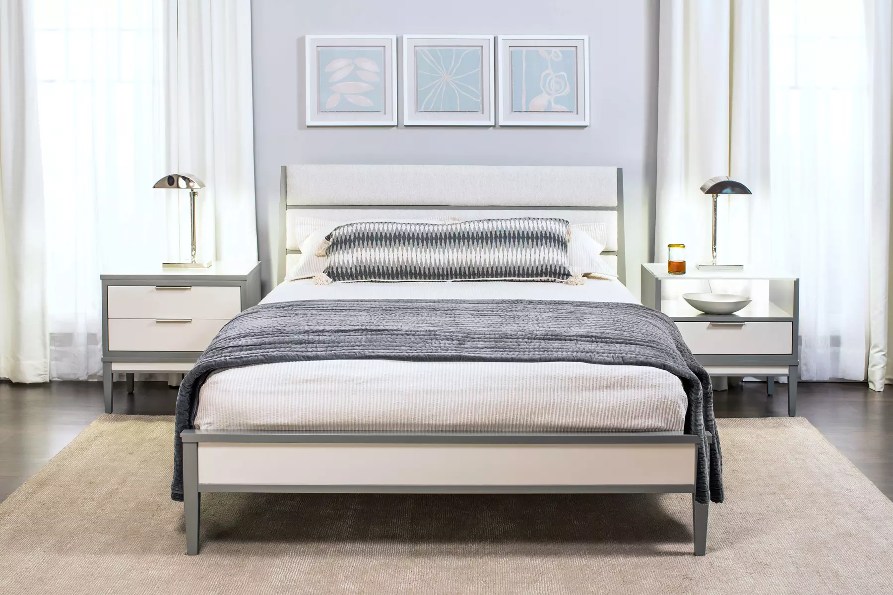 A bedroom with a bed , nightstands , and a rug.