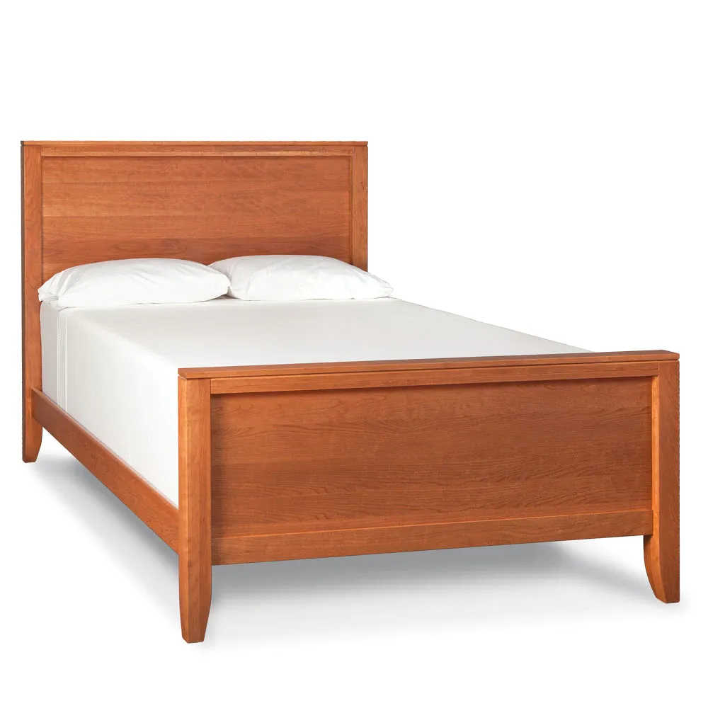 A wooden bed with white sheets and pillows