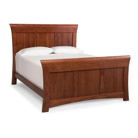 A wooden bed with white sheets and pillows on a white background