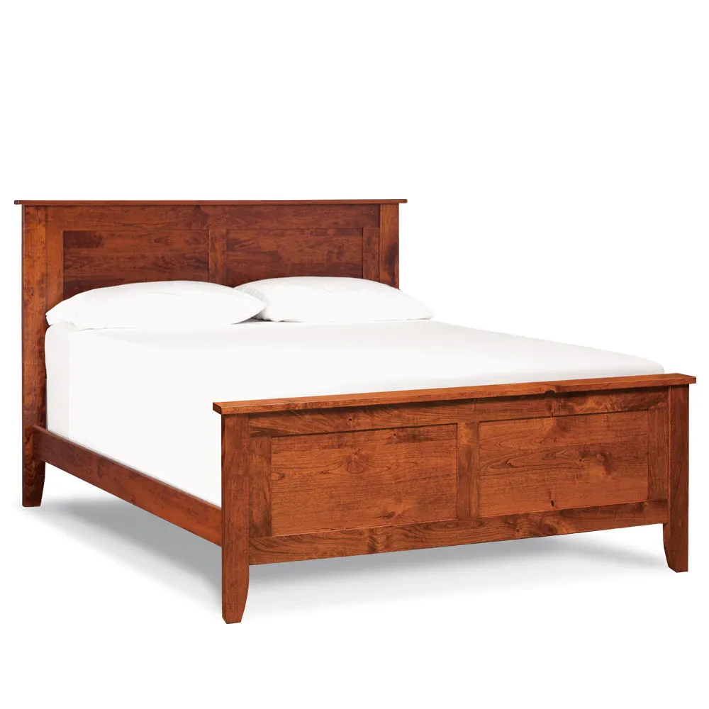 A wooden bed frame with white sheets and pillows