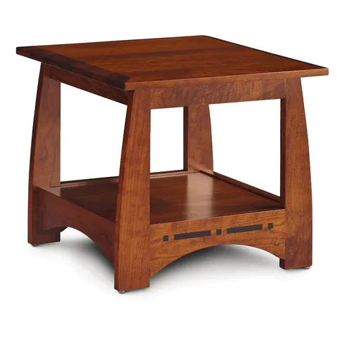 A small wooden table with a shelf underneath it