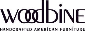 The logo for woodbine handcrafted american furniture is black and white.