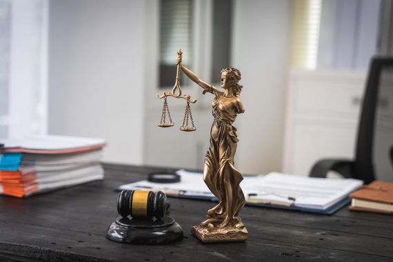 Lady Justice statue and gavel on a desk in an office setting