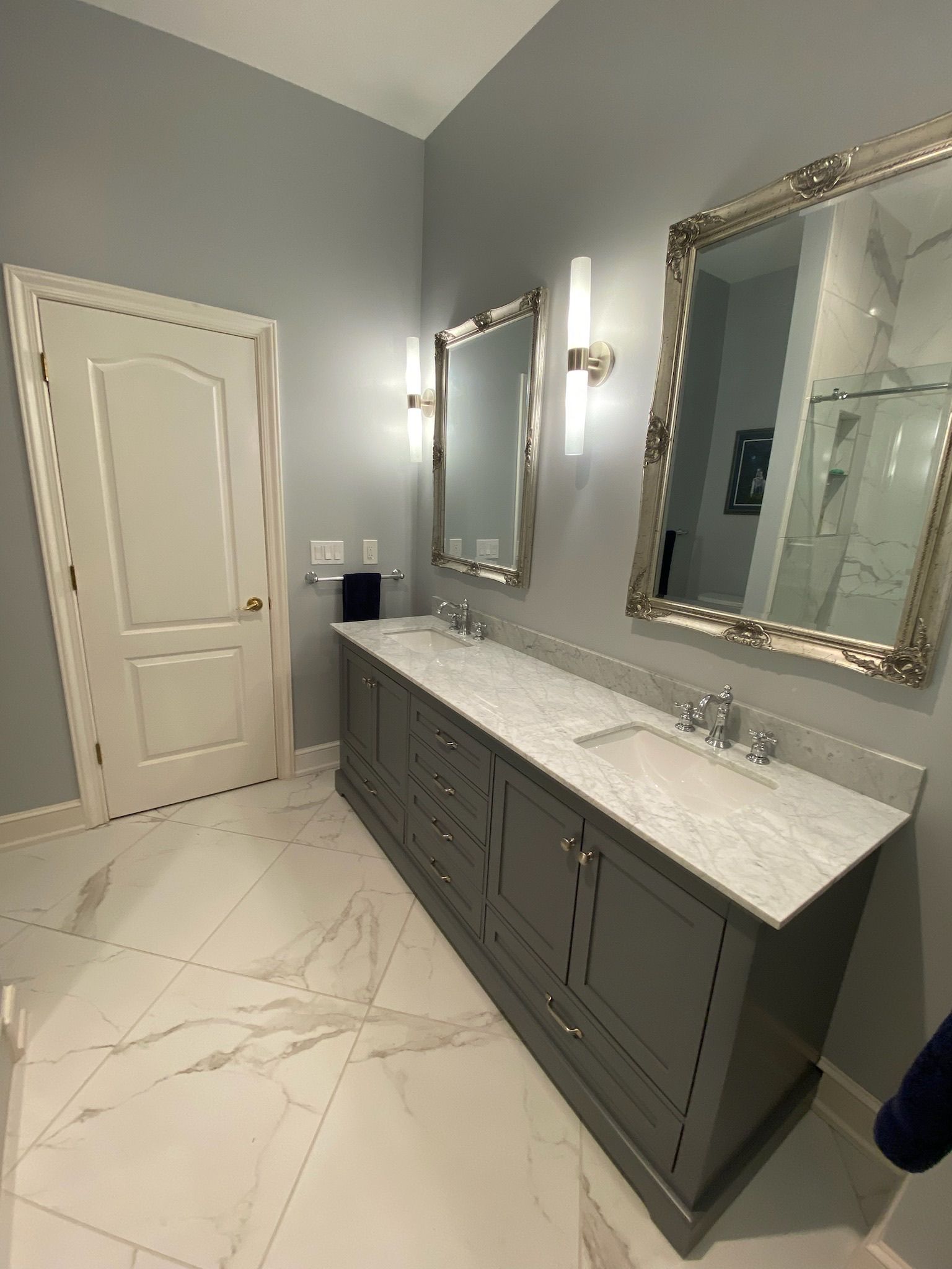 A bathroom with two sinks and two mirrors.