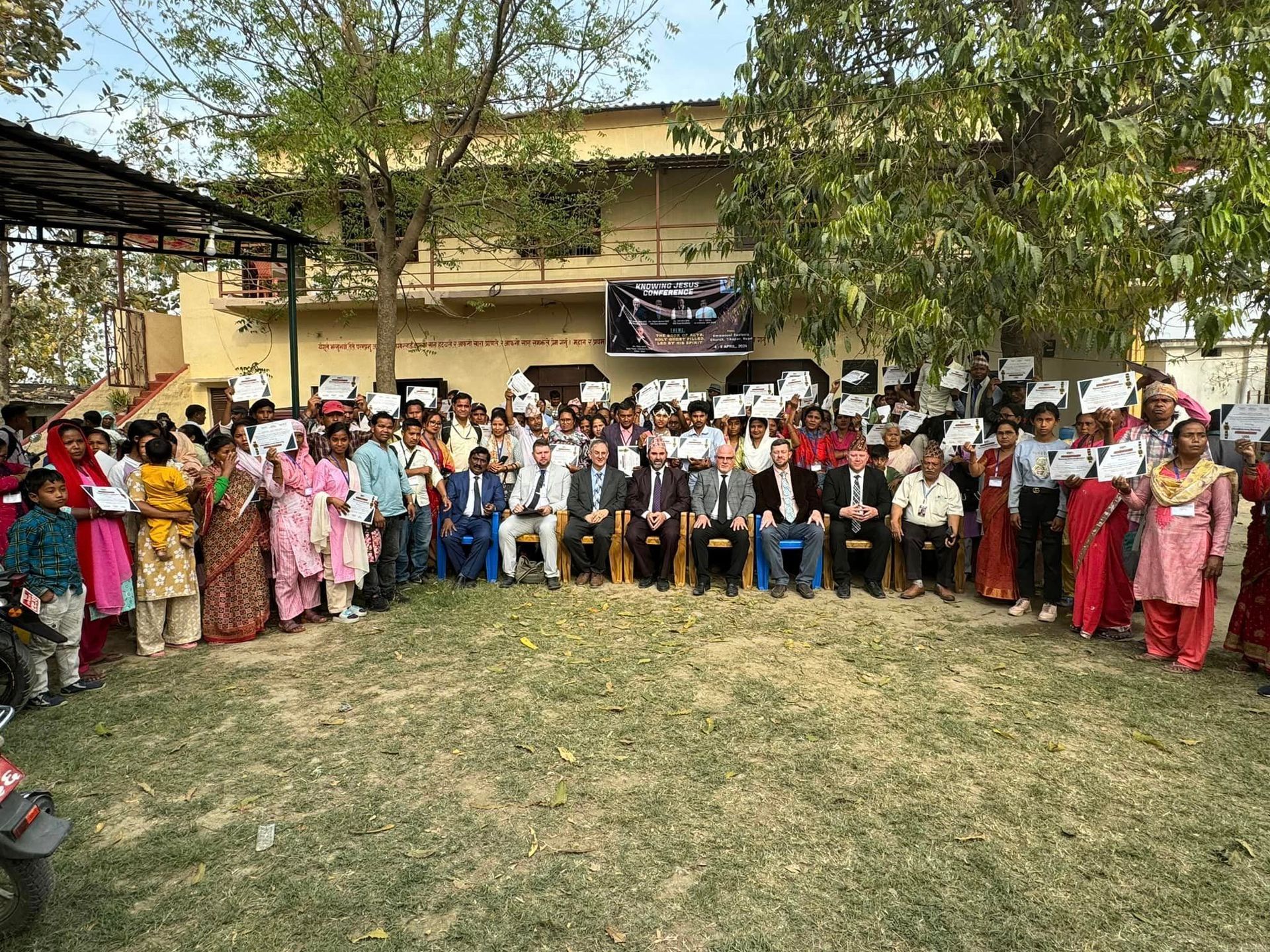 group at Nopal India. bright colorful ladies and gentlemen dressed in front of mission