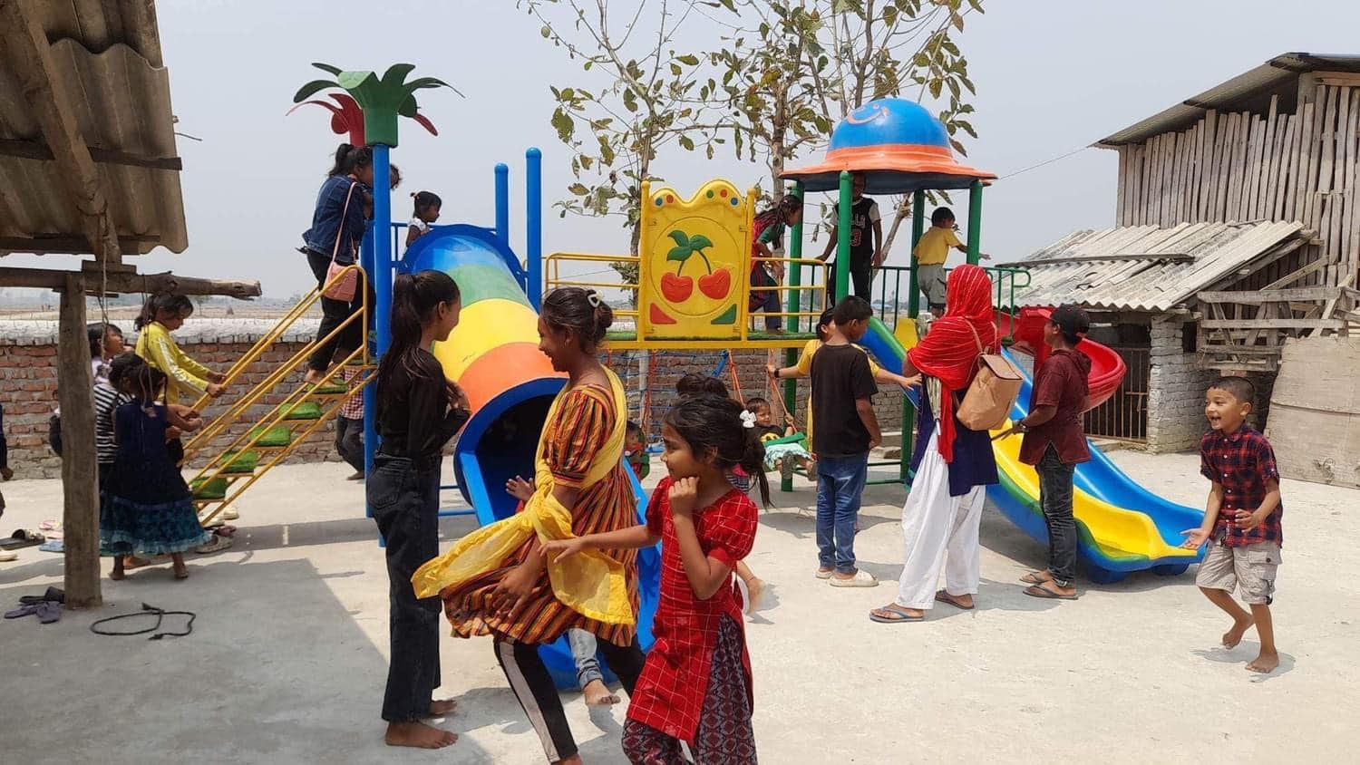 children dressed in colorful clothes playing in a playground