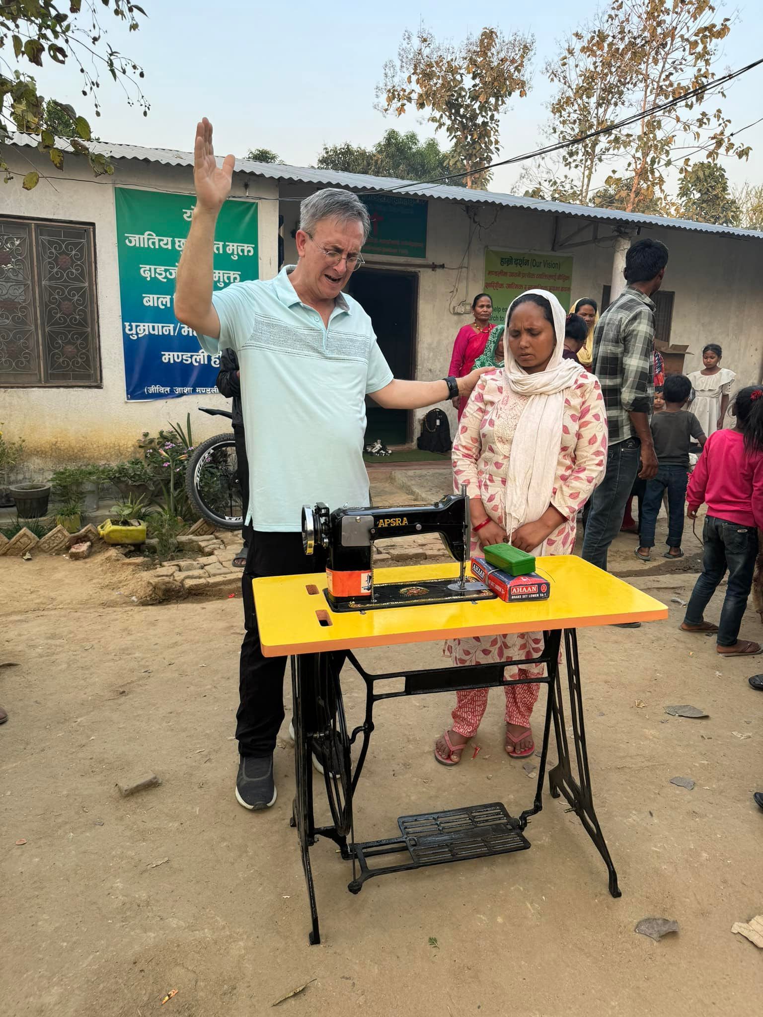 lady and a man standing at a sewing machine