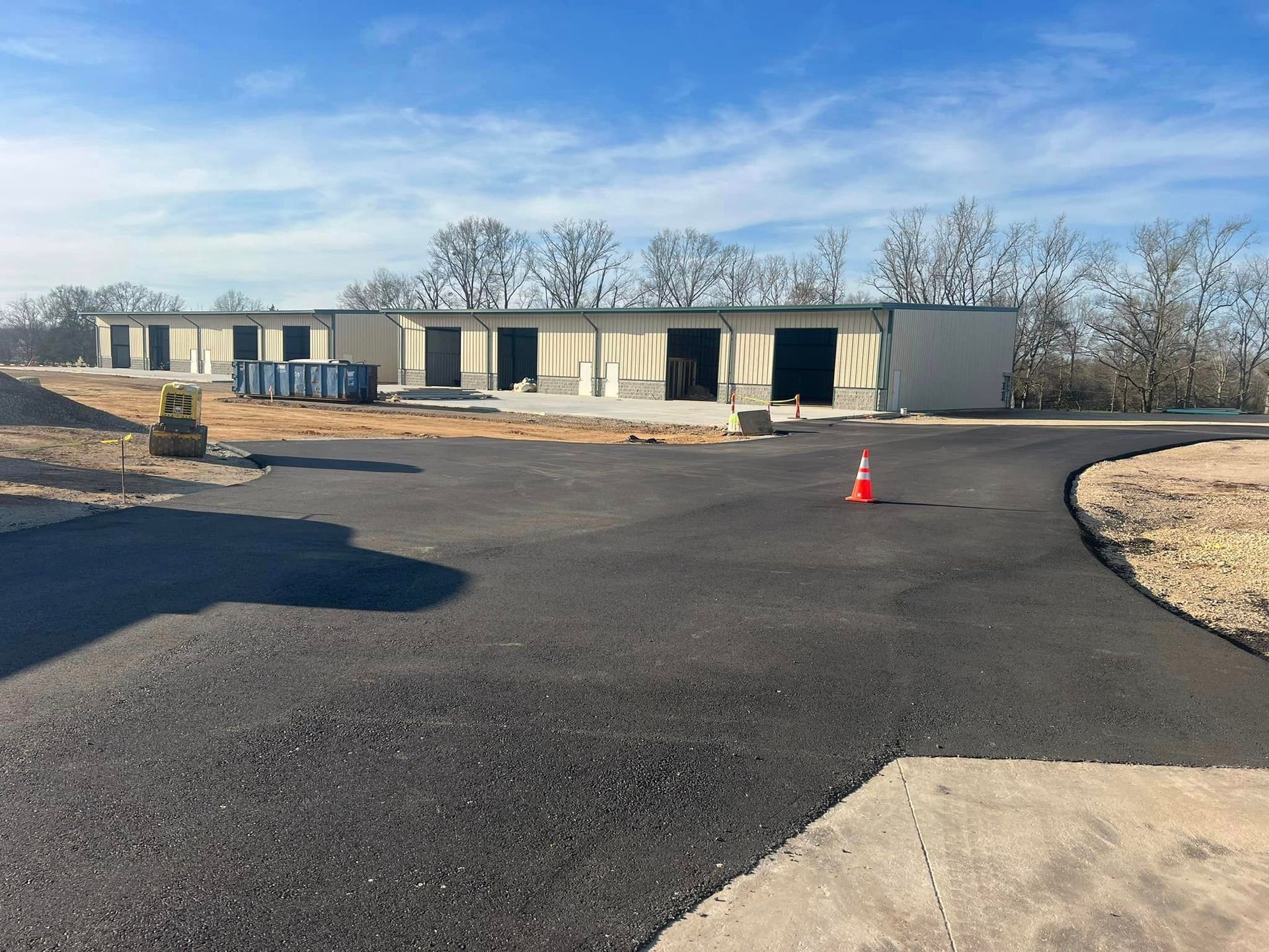 A large building is being built in the middle of a parking lot.