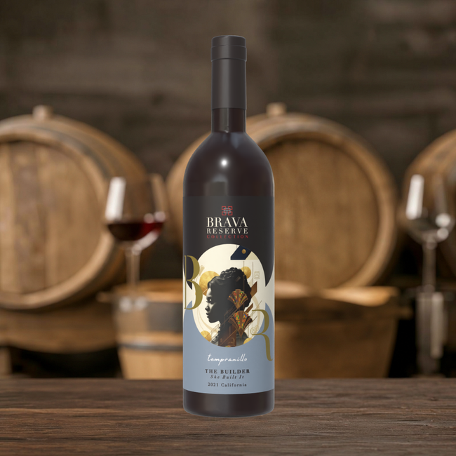 Wine bottle centered on a rustic table, with barrels and wine glasses blurred in the background.