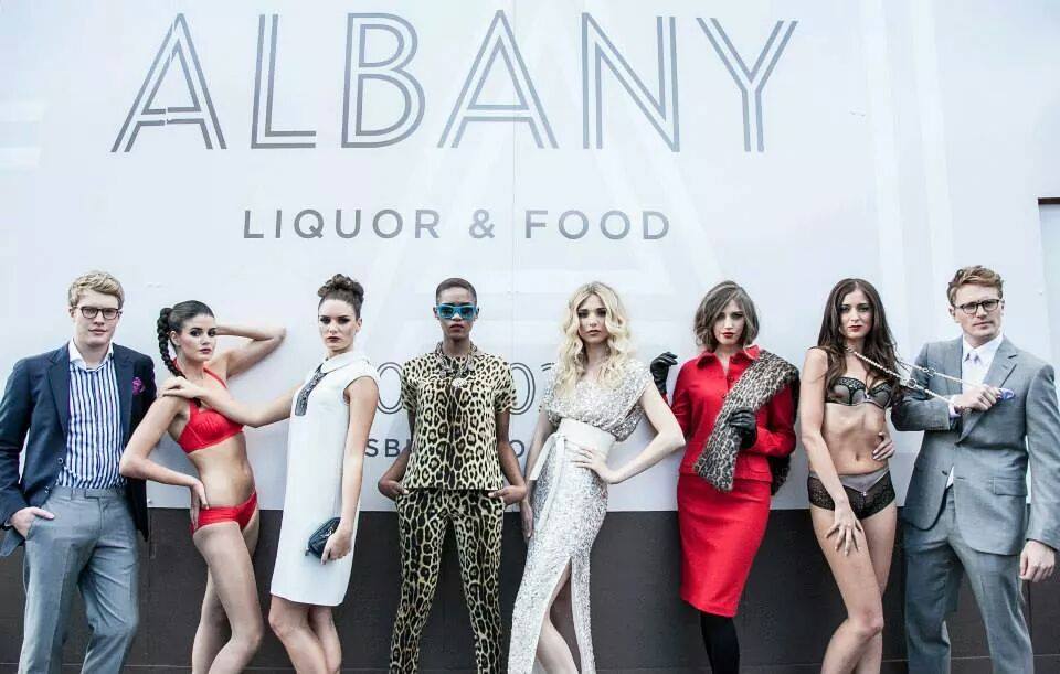 Albany ad with row of models wearing abstract outfits