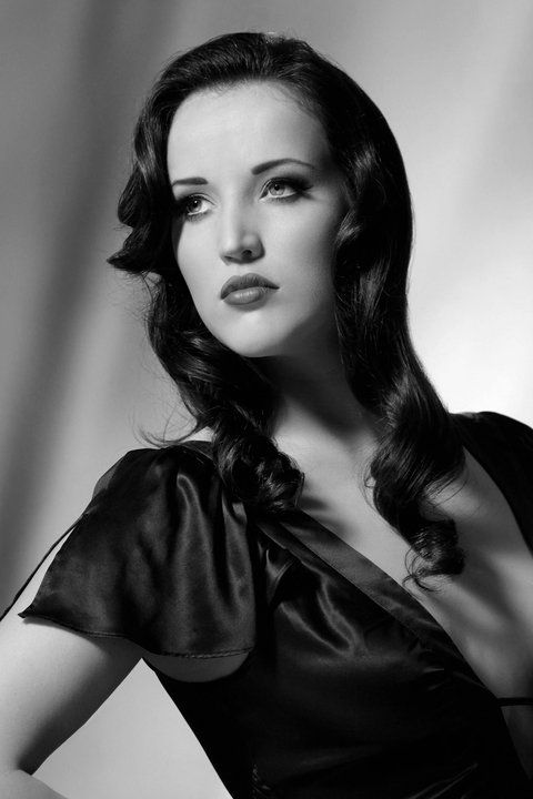Black and white 50s styled photo of woman looking away from camera