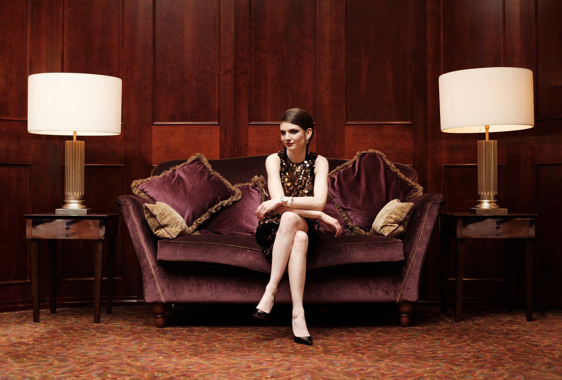 Woman sat on large red sofa