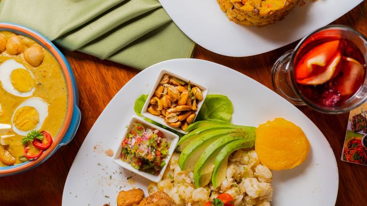 A table topped with plates of food and a bowl of soup.