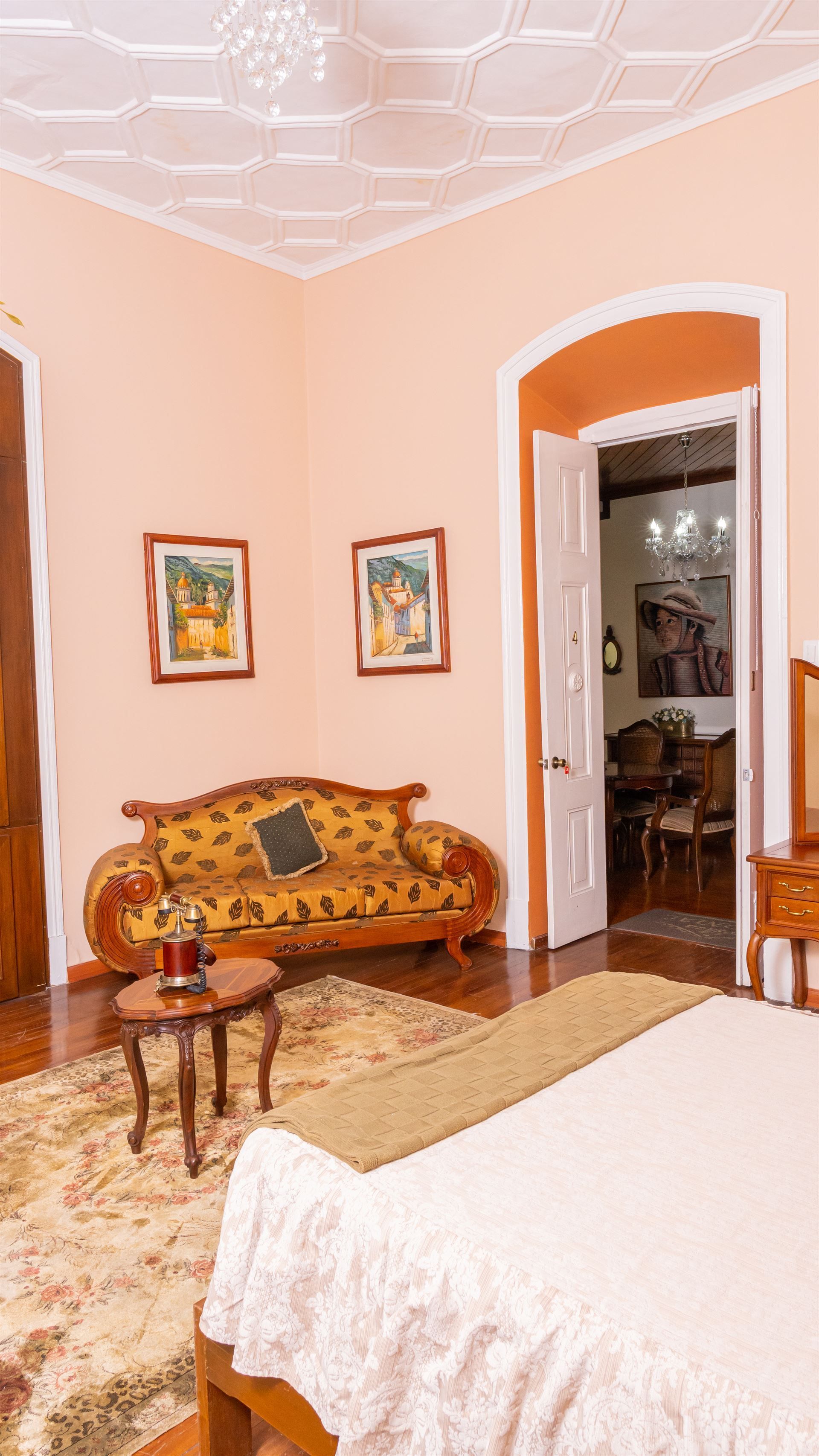 A bedroom with a bed , couch , table and rug.