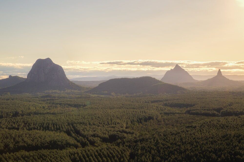 An Aerial View of a Landscape With Mountains and Trees at Sunset — Whirly Bird King In Caboolture, QLD