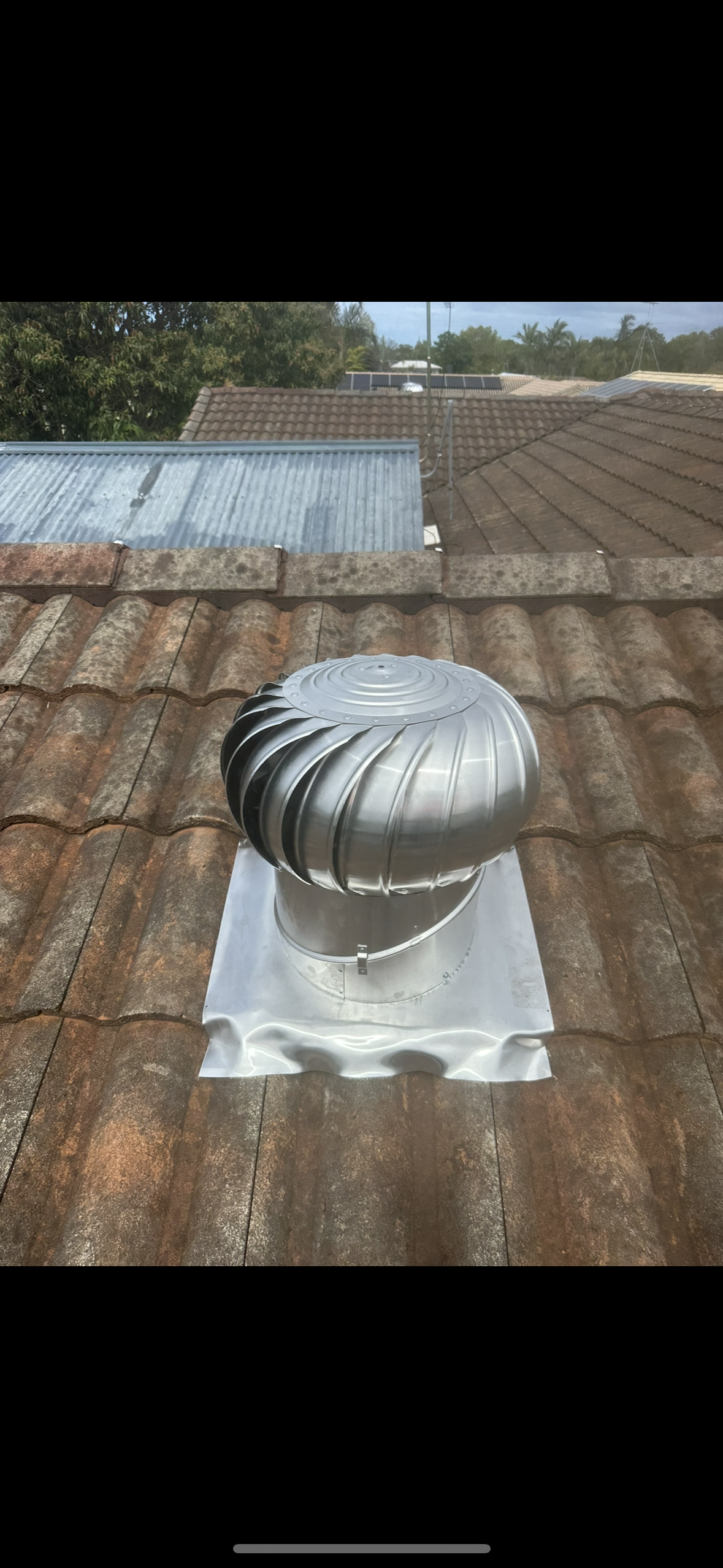 Close-up of a Terracotta Tile Roof With a Curved Edge — Whirly Bird King in Strathpine, QLD